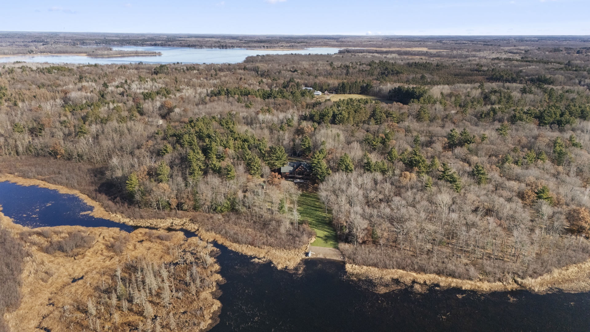 Full aerial view of The Long Lake Lodge property with lake and grounds