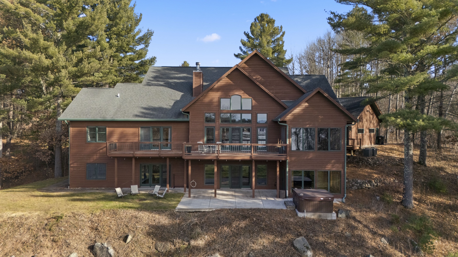 Aerial view of rear deck overlooking Long Lake with outdoor seating areas