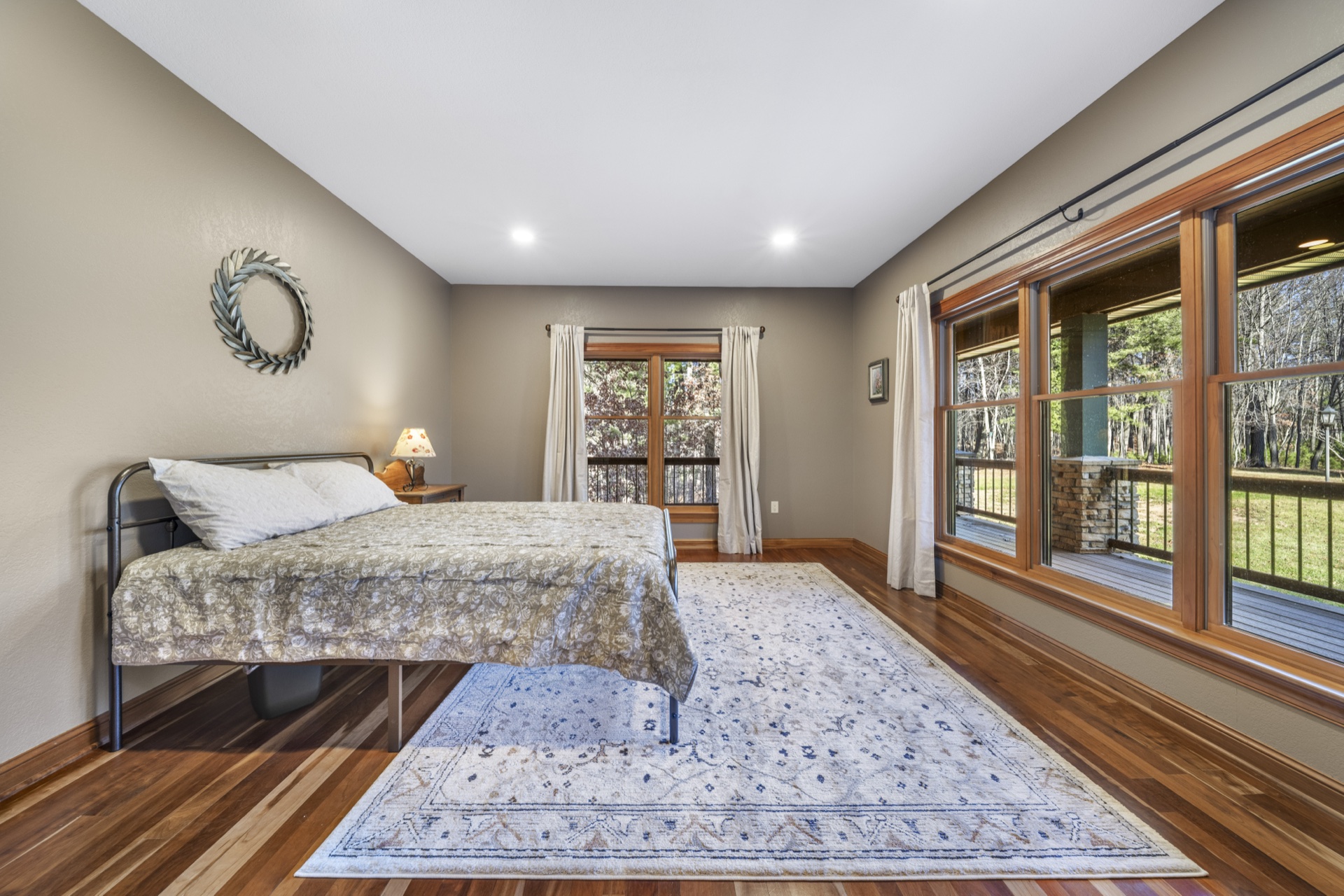 Upper level guest bedroom with quality furnishings and natural light